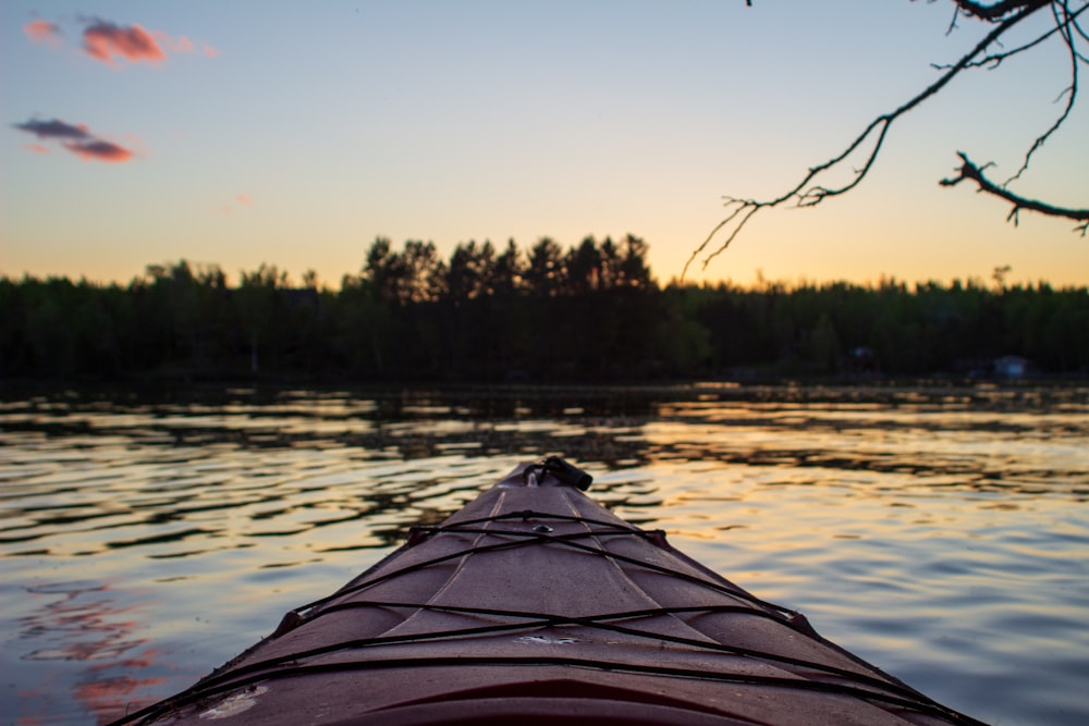 maroon kayak on water during daytime