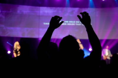 Close-up of hands in the air enjoying a groove-filled live performance.