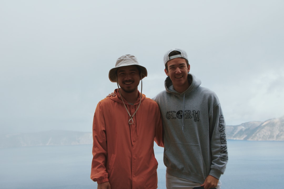 two men wearing hoodies