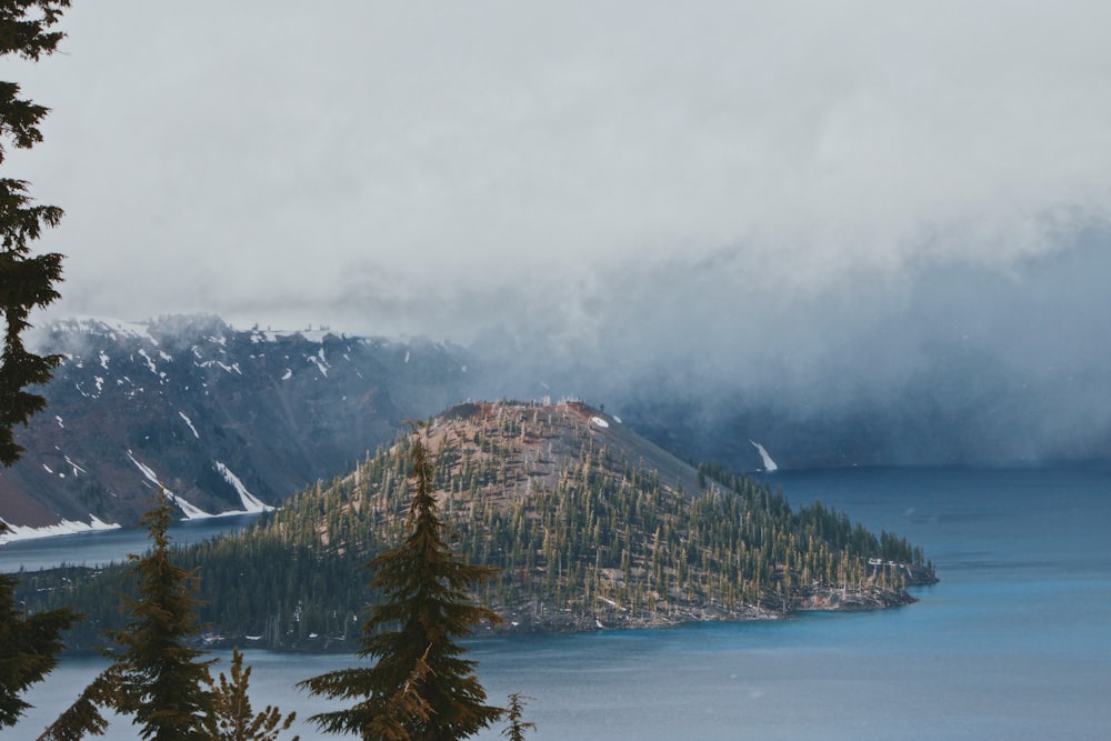 green mountain near body of water during daytime