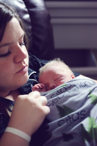 A pregnant woman having a checkup with a healthcare provider using a handheld ultrasound device