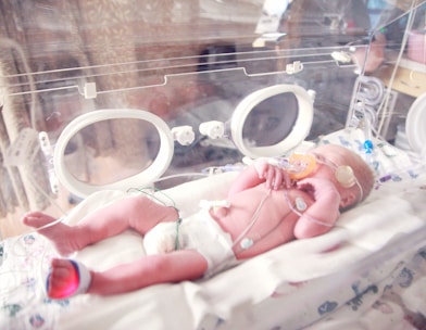 baby lying in incubator