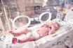 baby lying in incubator