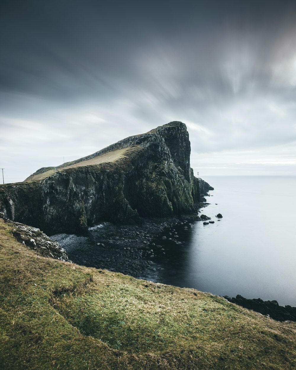 cliff beside body of water