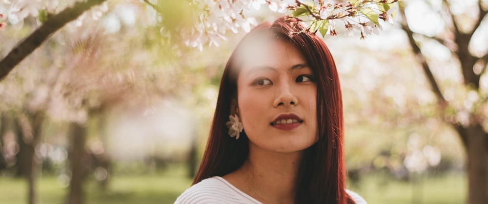 smiling woman under trees