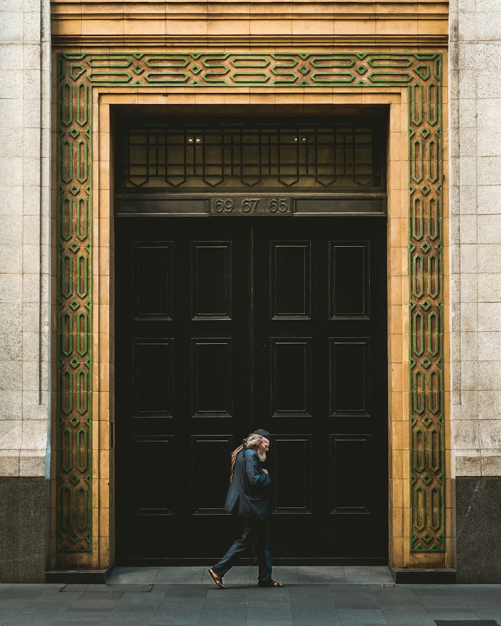 person walking in front of black wooden door
