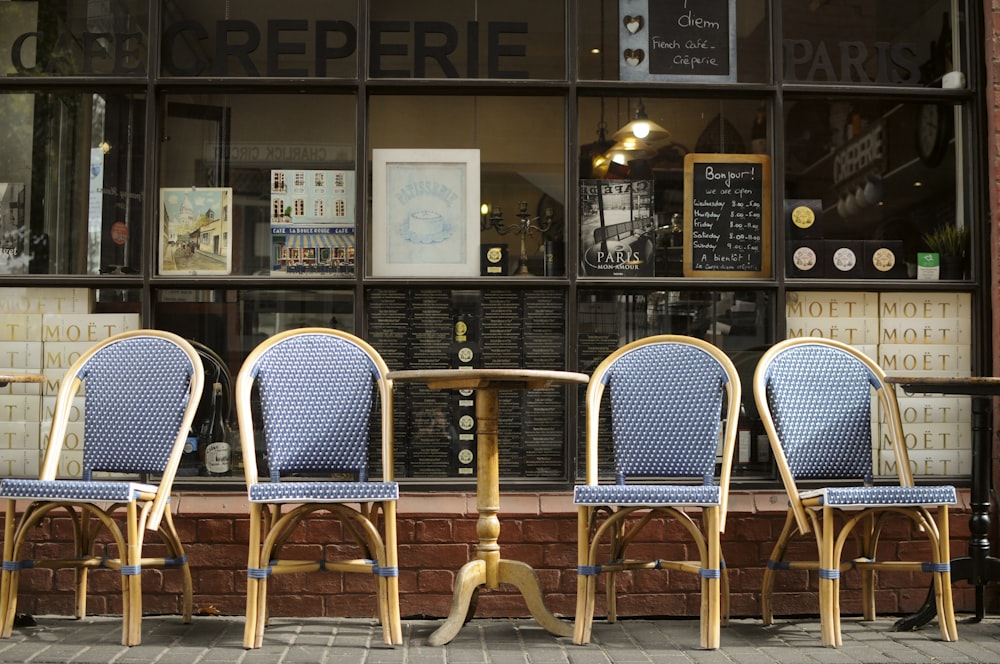 four vacant blue armless chairs outside building