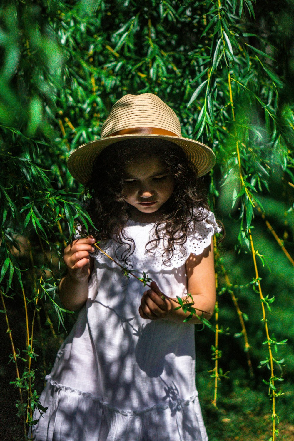 girl standing beside tree