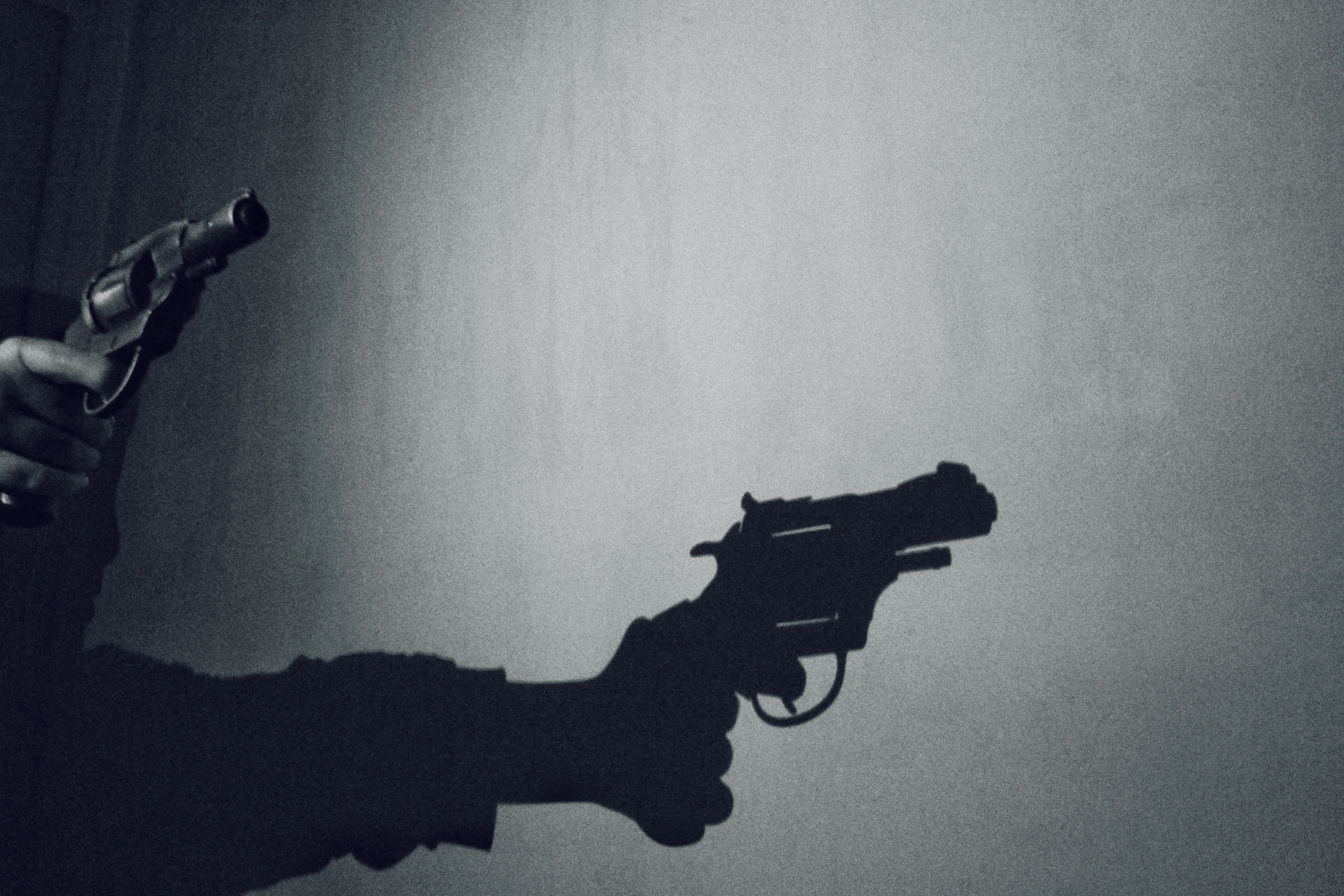 A stark black-and-white comic panel featuring a lone gunslinger silhouetted against a blood-red sunset, with gritty textures and bold shadows.