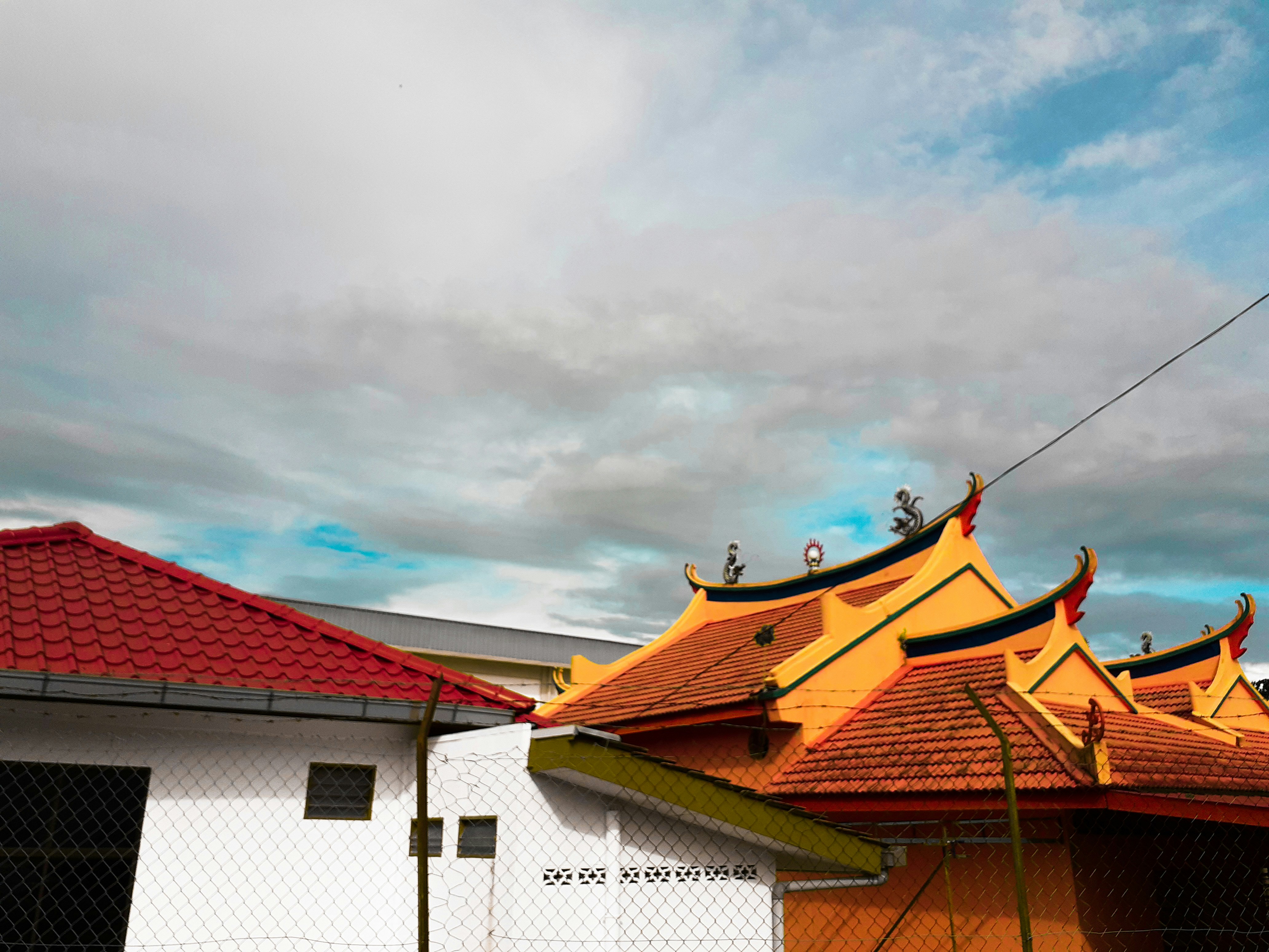 yellow and yellow temple near white concrete house