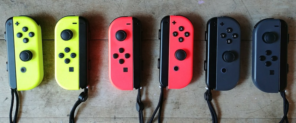three Nintendo Switch handheld game consoles