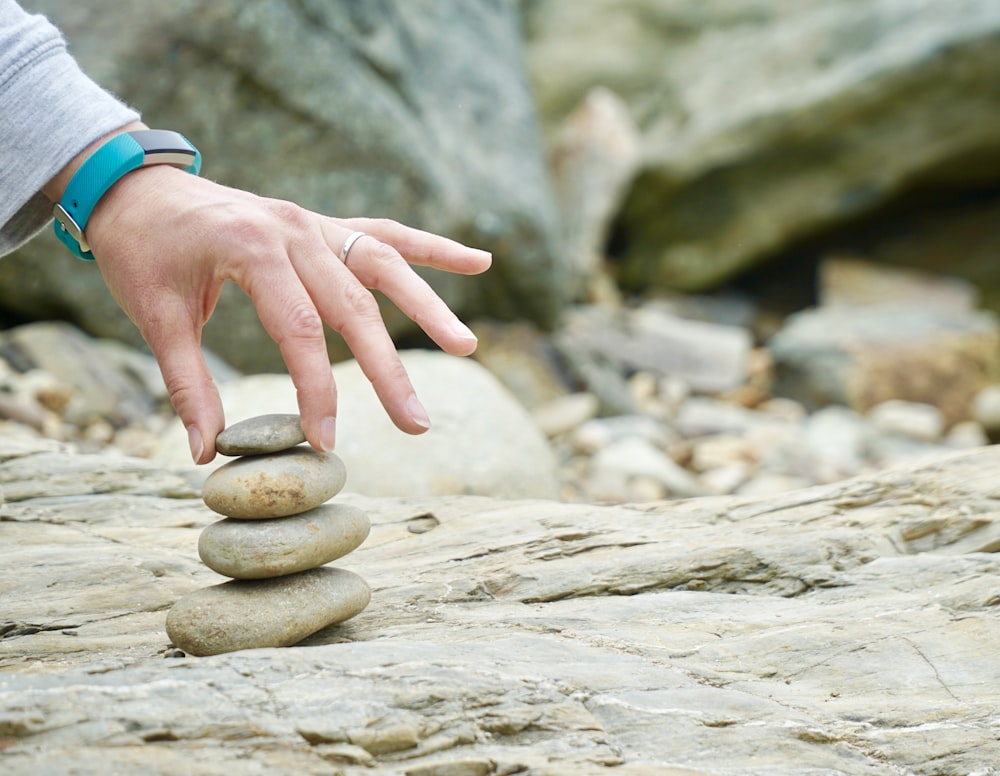 person piling brown stones