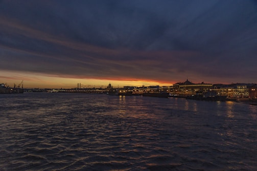 A romantic sunset view of Copenhagen's waterfront with the city lights beginning to twinkle.