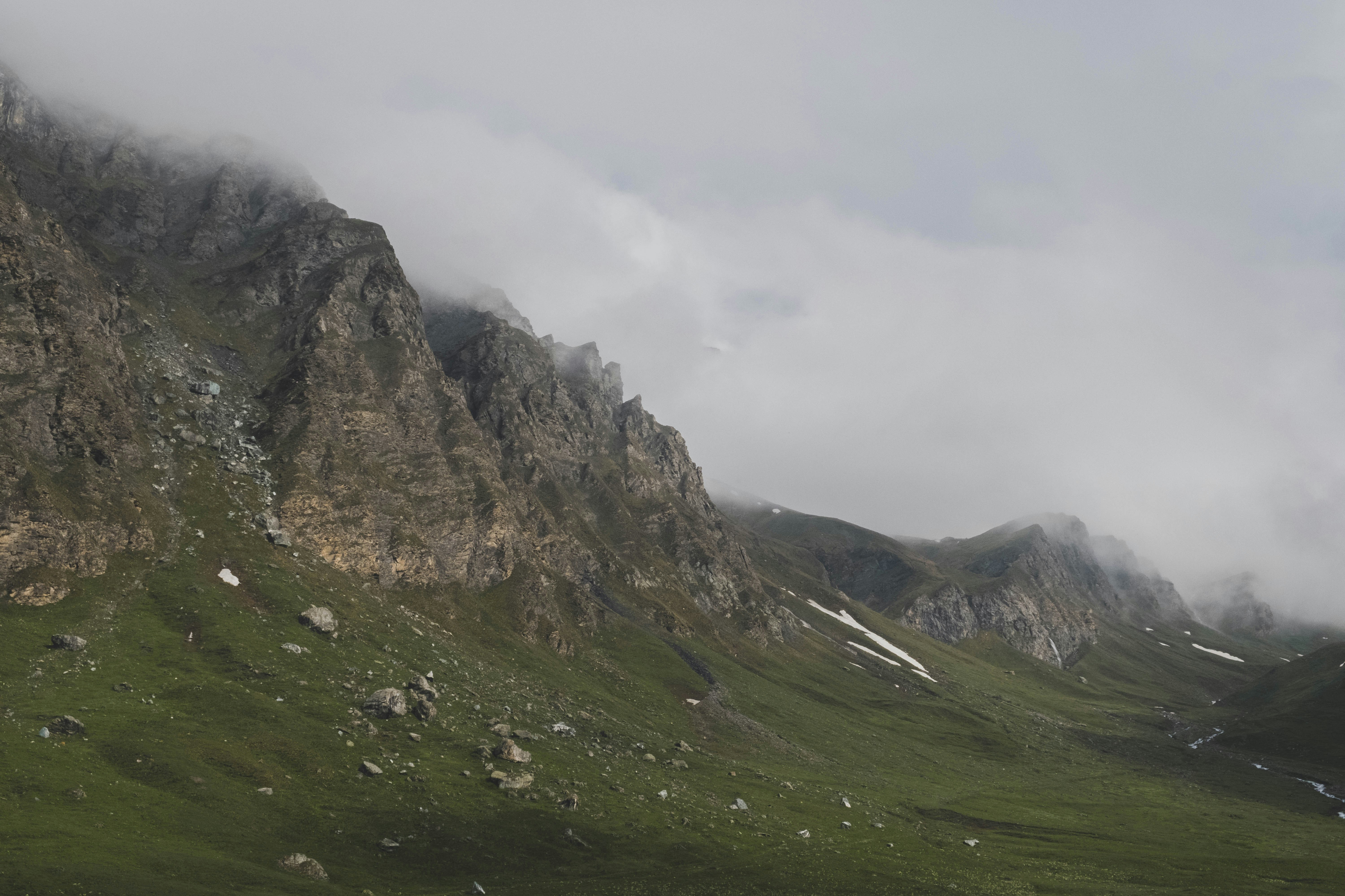landscape photography of green and brown mountain, Nine in the morning, we are back on our bikes to cross the Col d