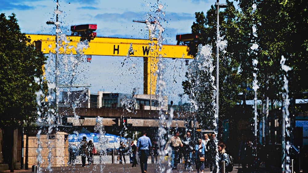 people walking near yellow structure