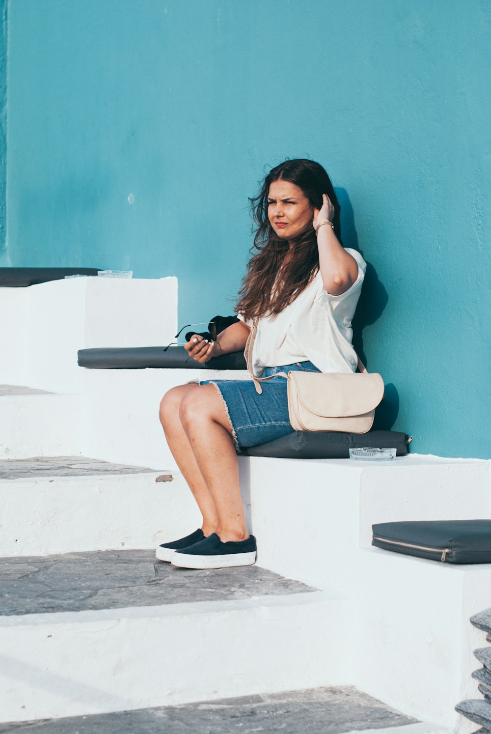 woman sitting on white stair