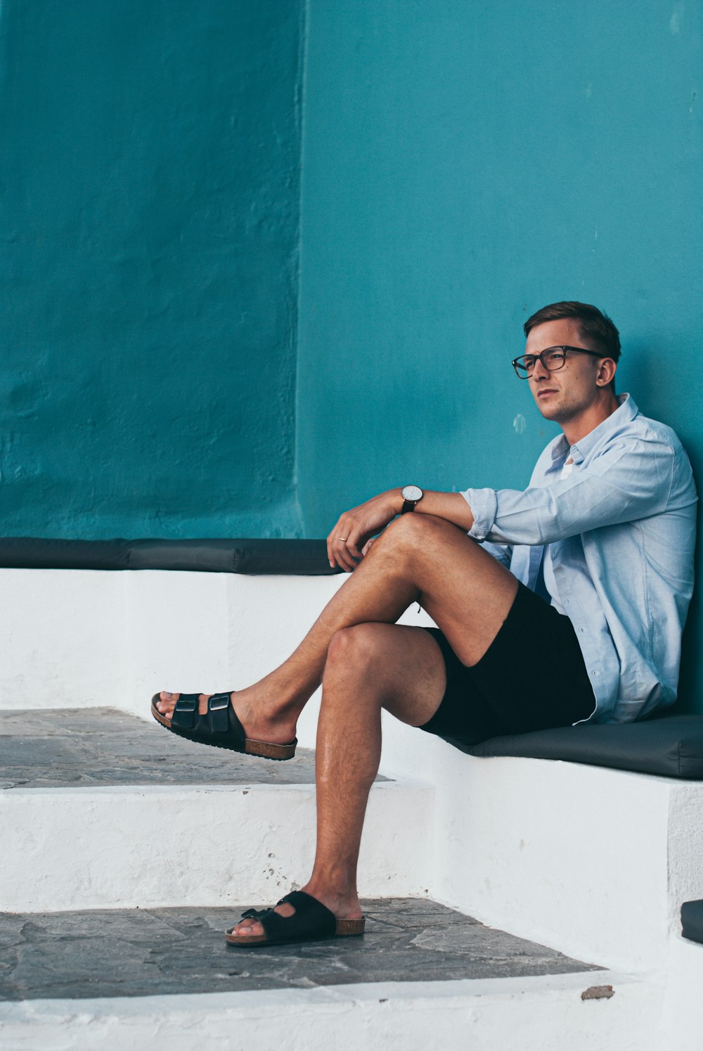 man sitting on white surface