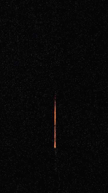 Close-up of a V16 beacon with vibrant orange light against a black background