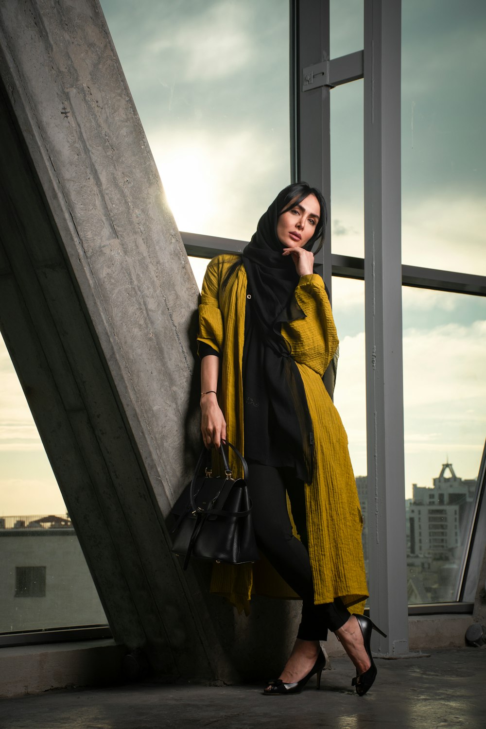 woman with brown coat standing in bridge