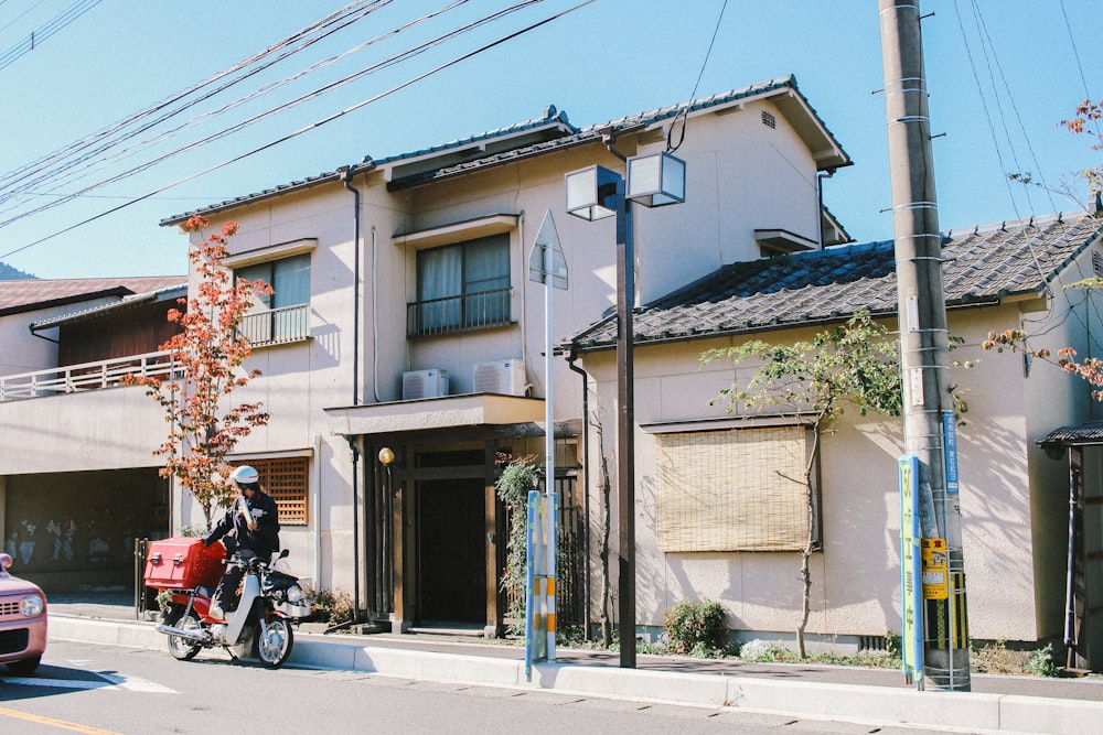 man standing beside house