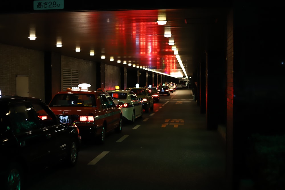 black, orange, and white cars on road