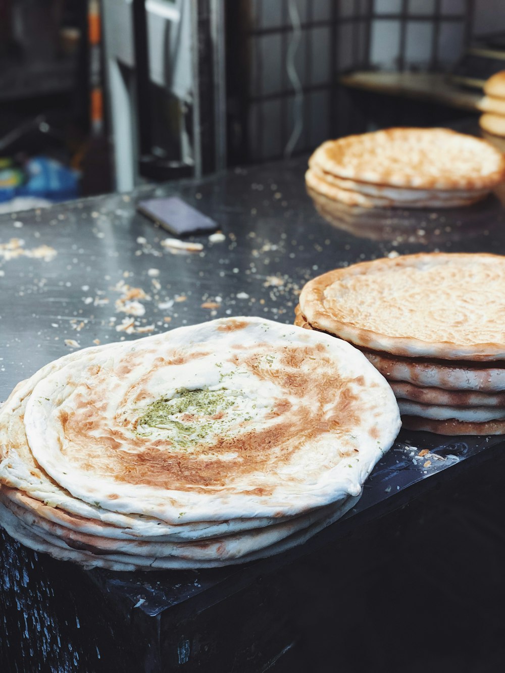 a stack of flat breads sitting on top of a counter
