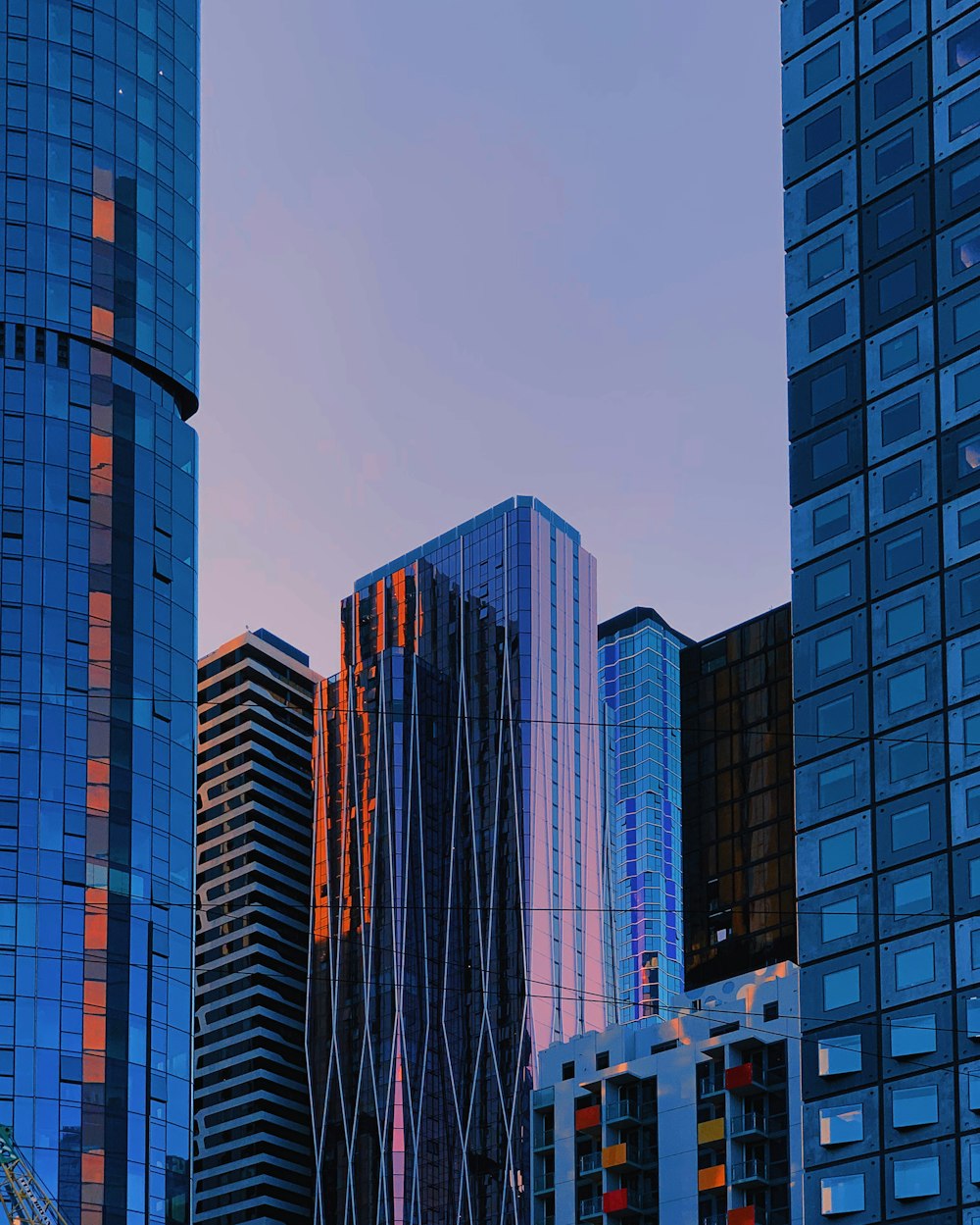 high rise buildings reflecting color of sky at sunset