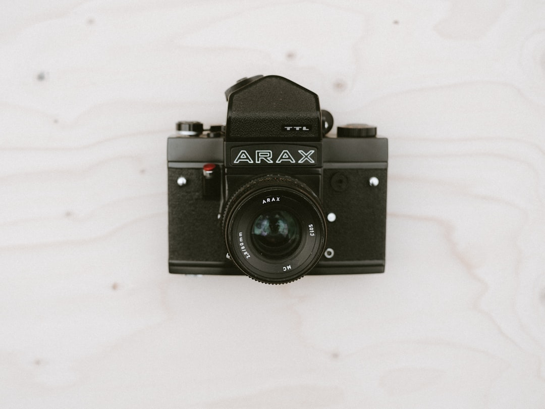 black Arax camera on beige surface