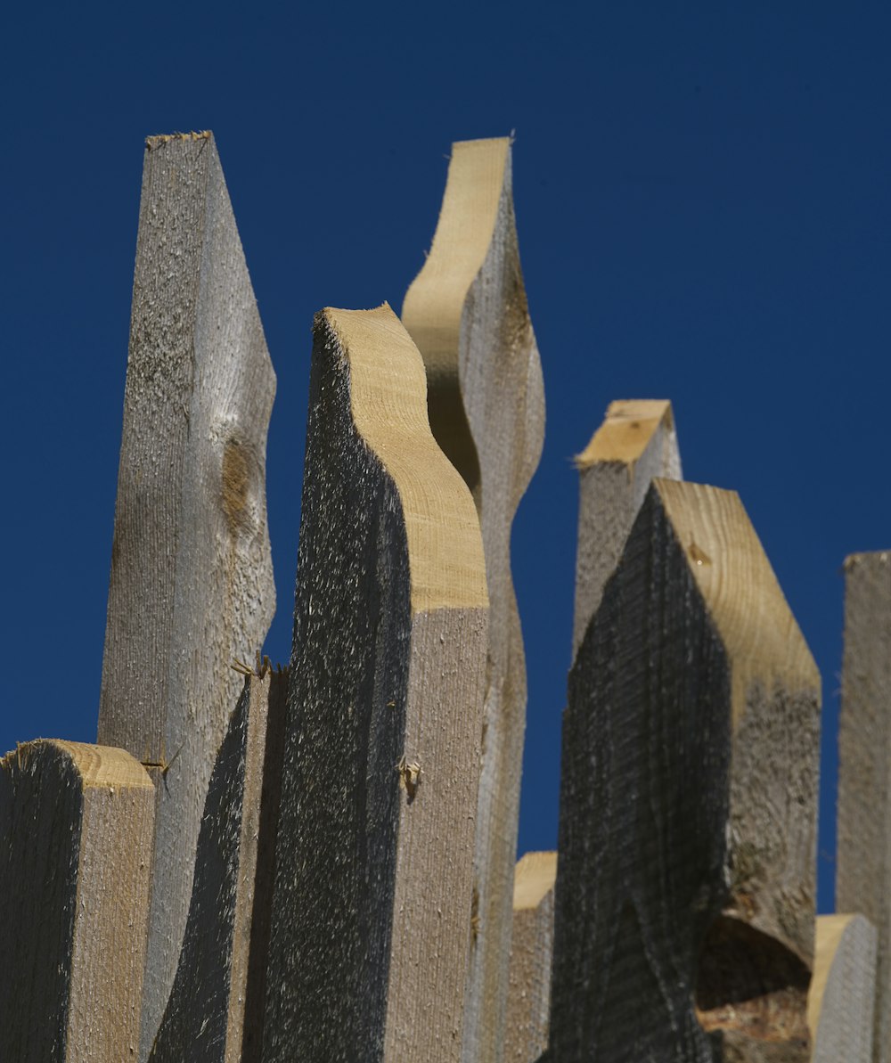a close up of a wooden fence against a blue sky