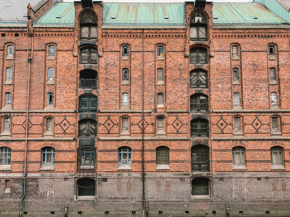 a large brick building with a green roof