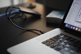 Close-up of hands working on a laptop with backup software running.