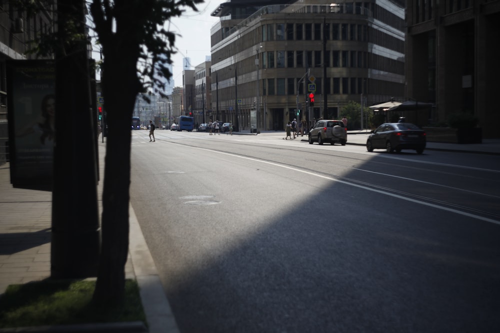 a person riding a bike down a street next to tall buildings