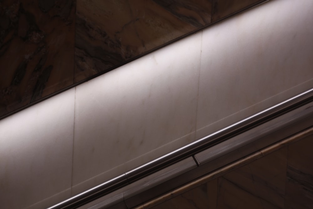 eine Rolltreppe in einem Gebäude mit einem Handlauf aus Metall
