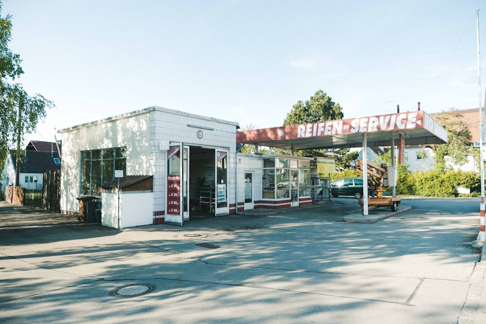 a gas station with a truck parked in front of it