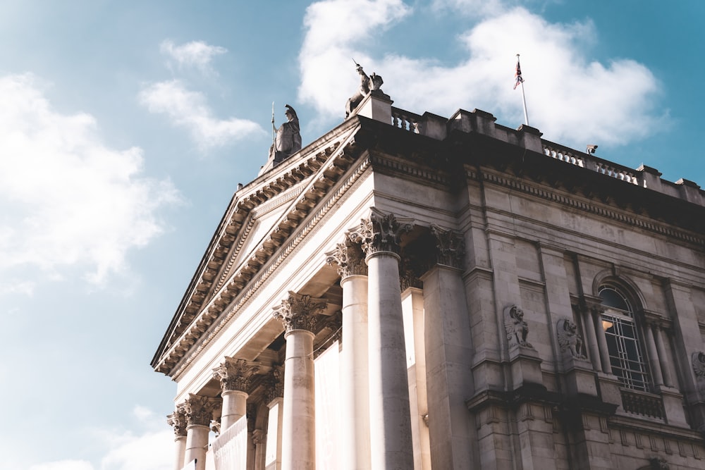 a tall building with columns and a sky background