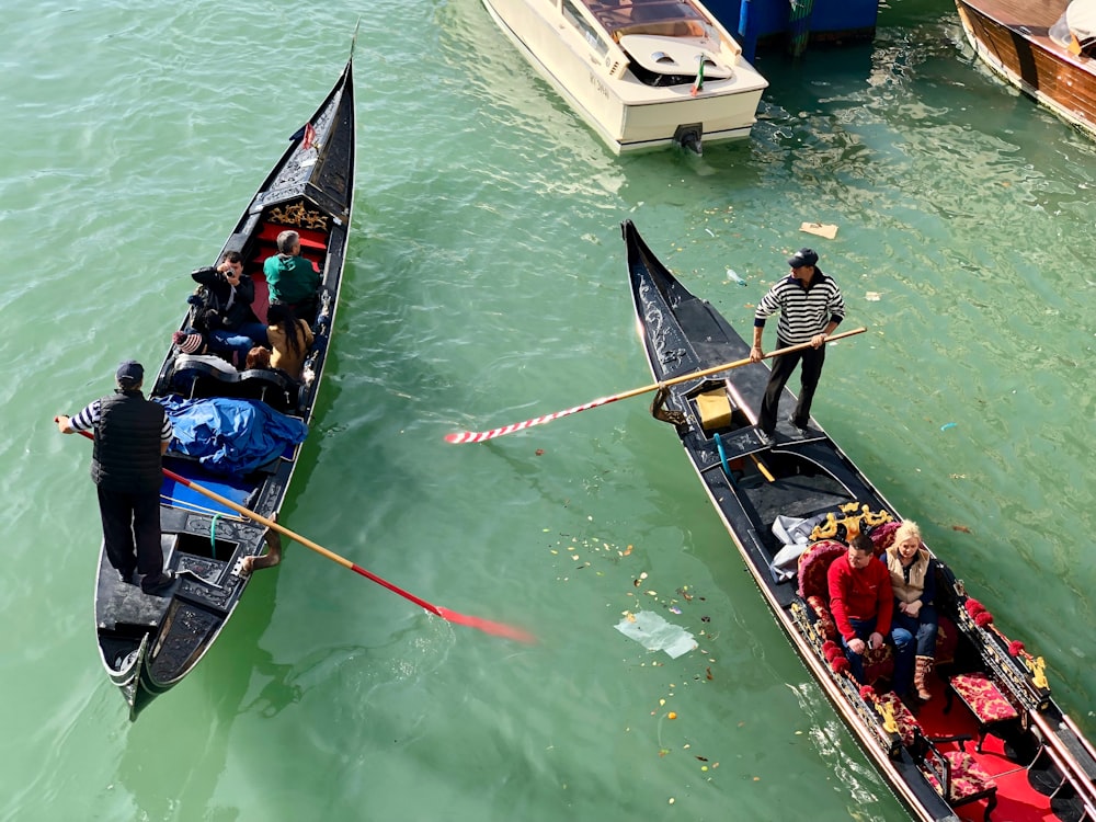 two gondolas with passengers in canal