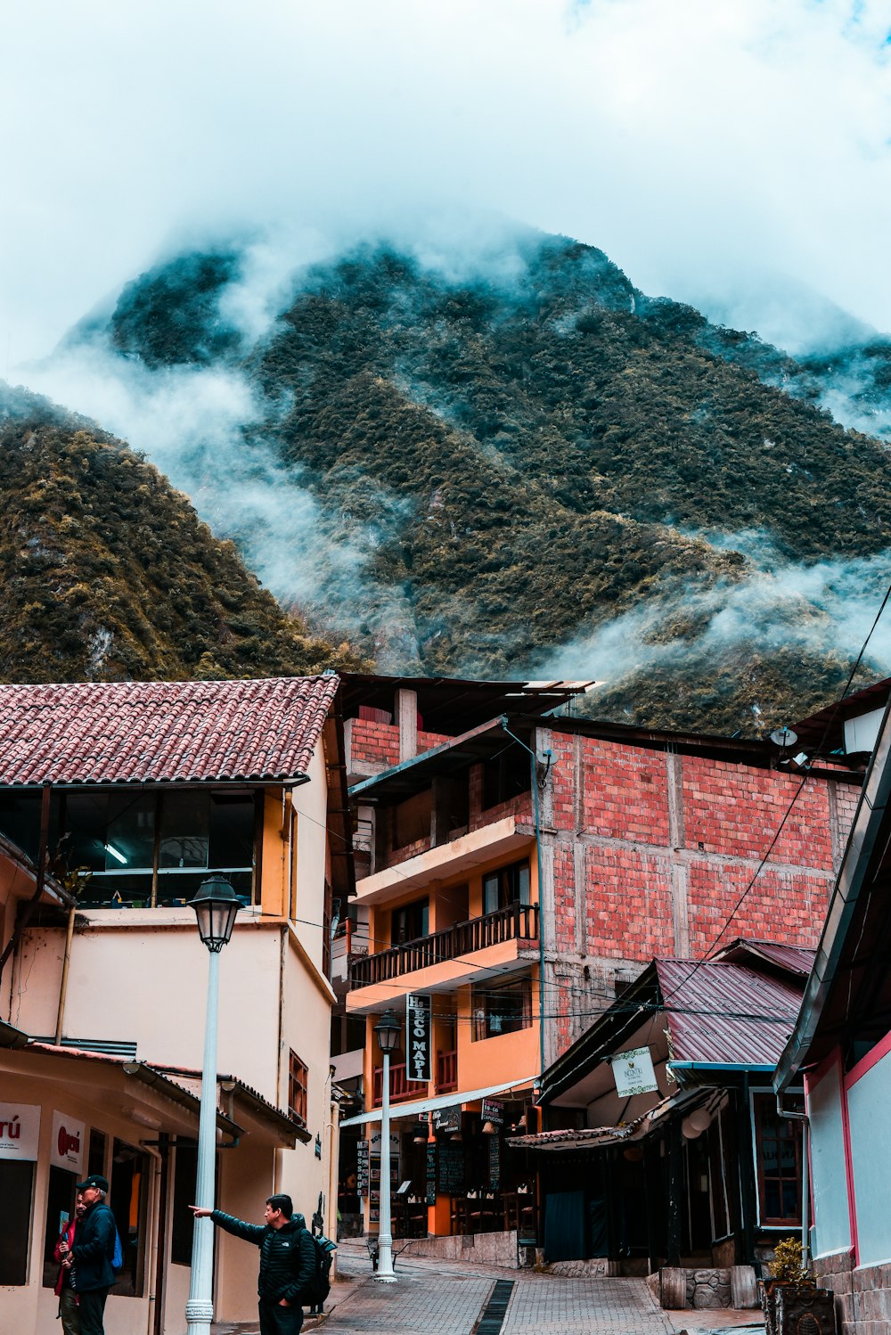 people walking beside houses