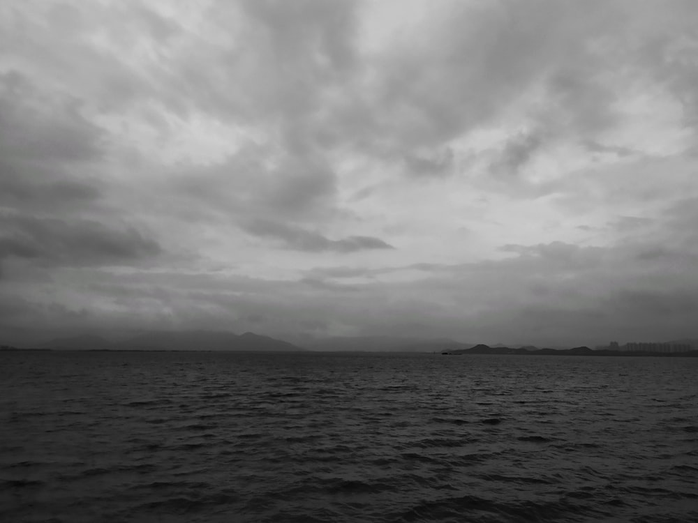 a large body of water under a cloudy sky