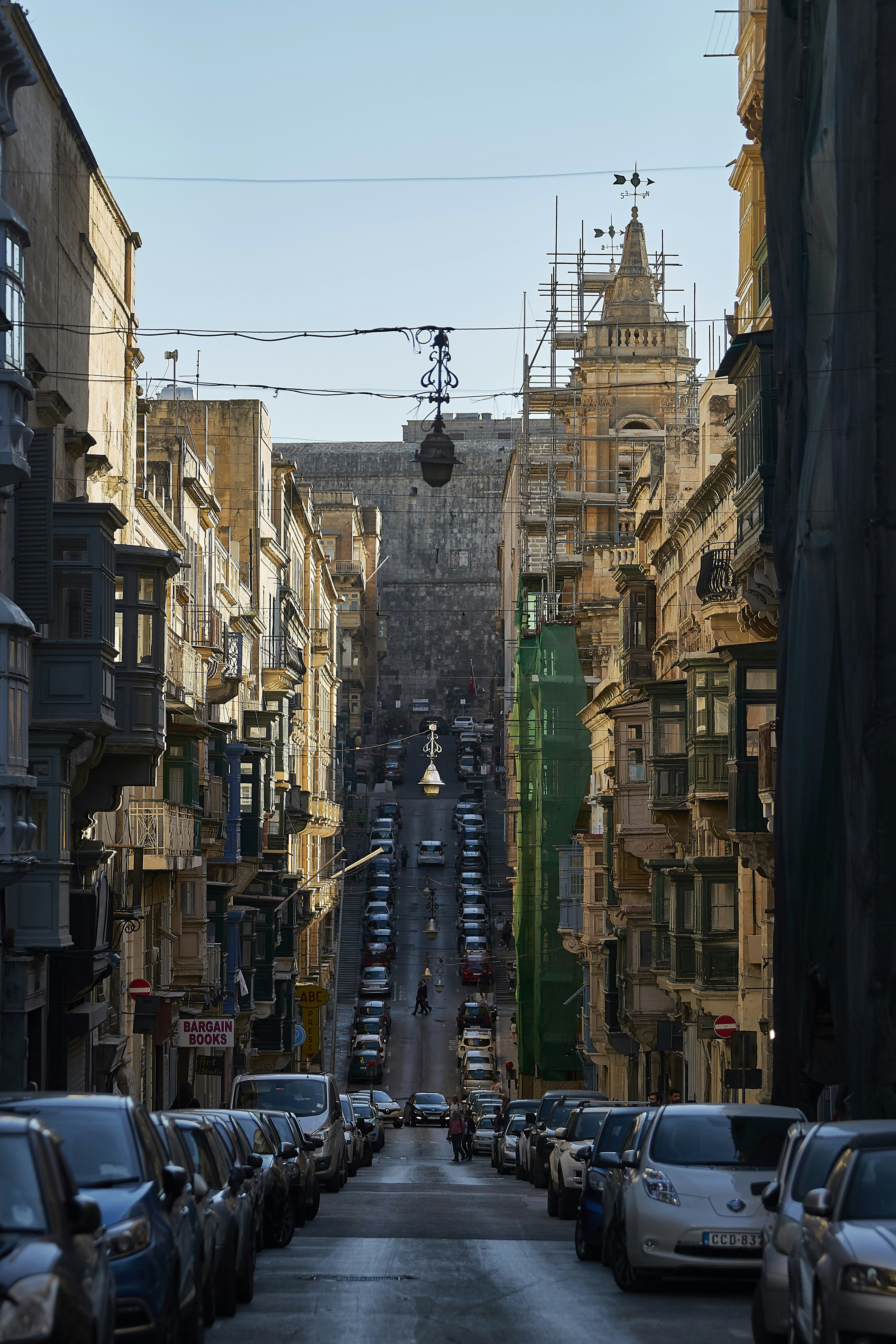 urban photo of a city street with parked cars