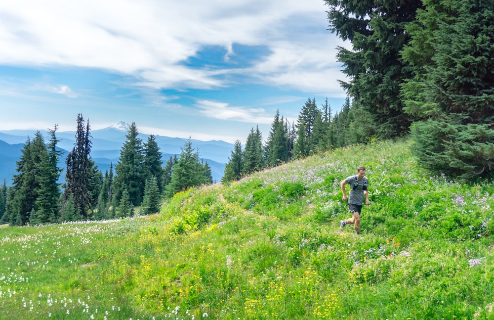 man running in a grassy field