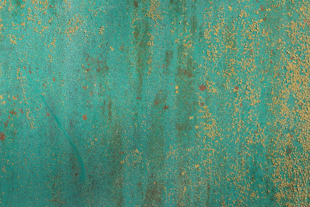 a close up of a green and gold wall