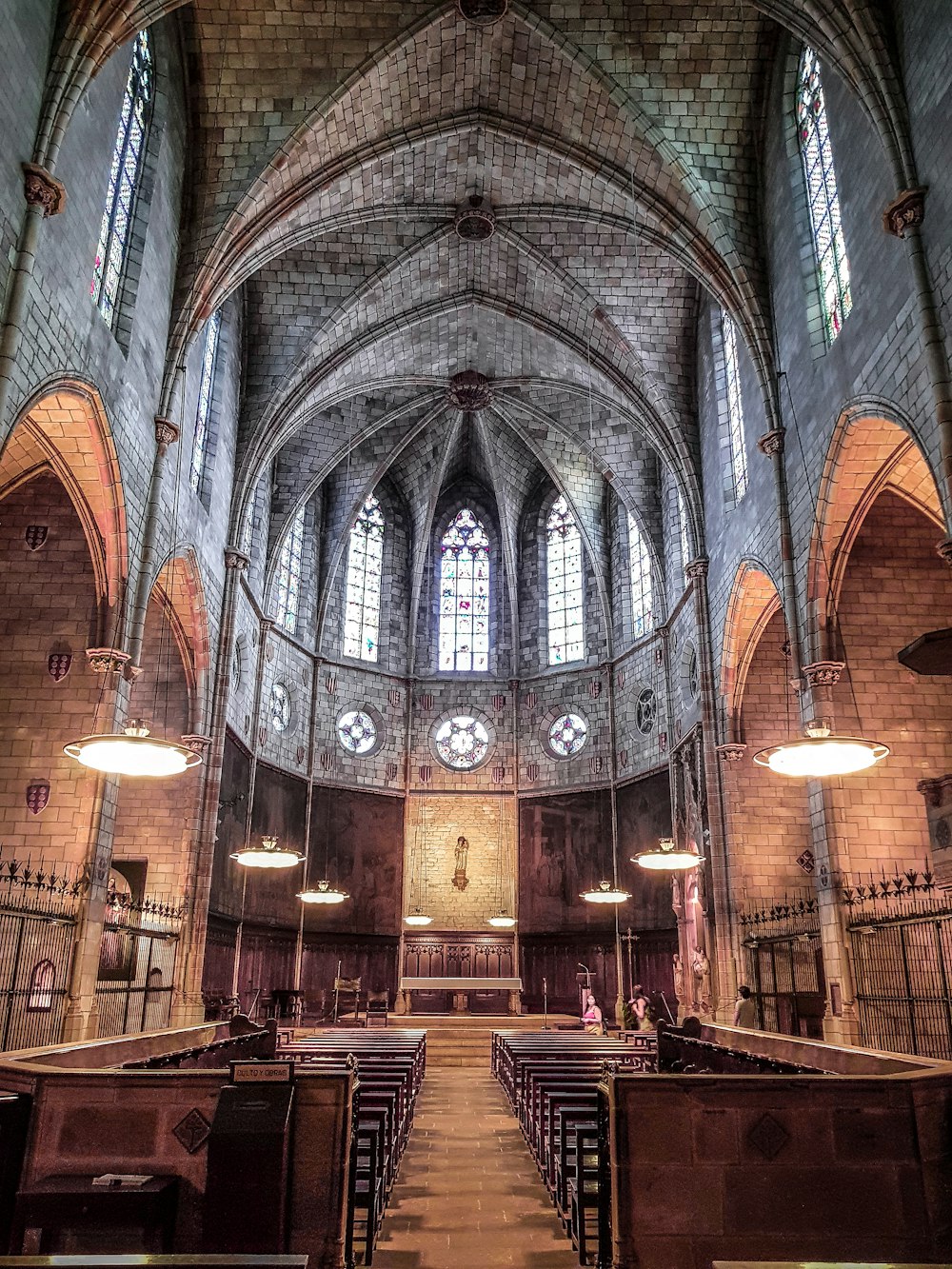 the inside of a church with pews and stained glass windows