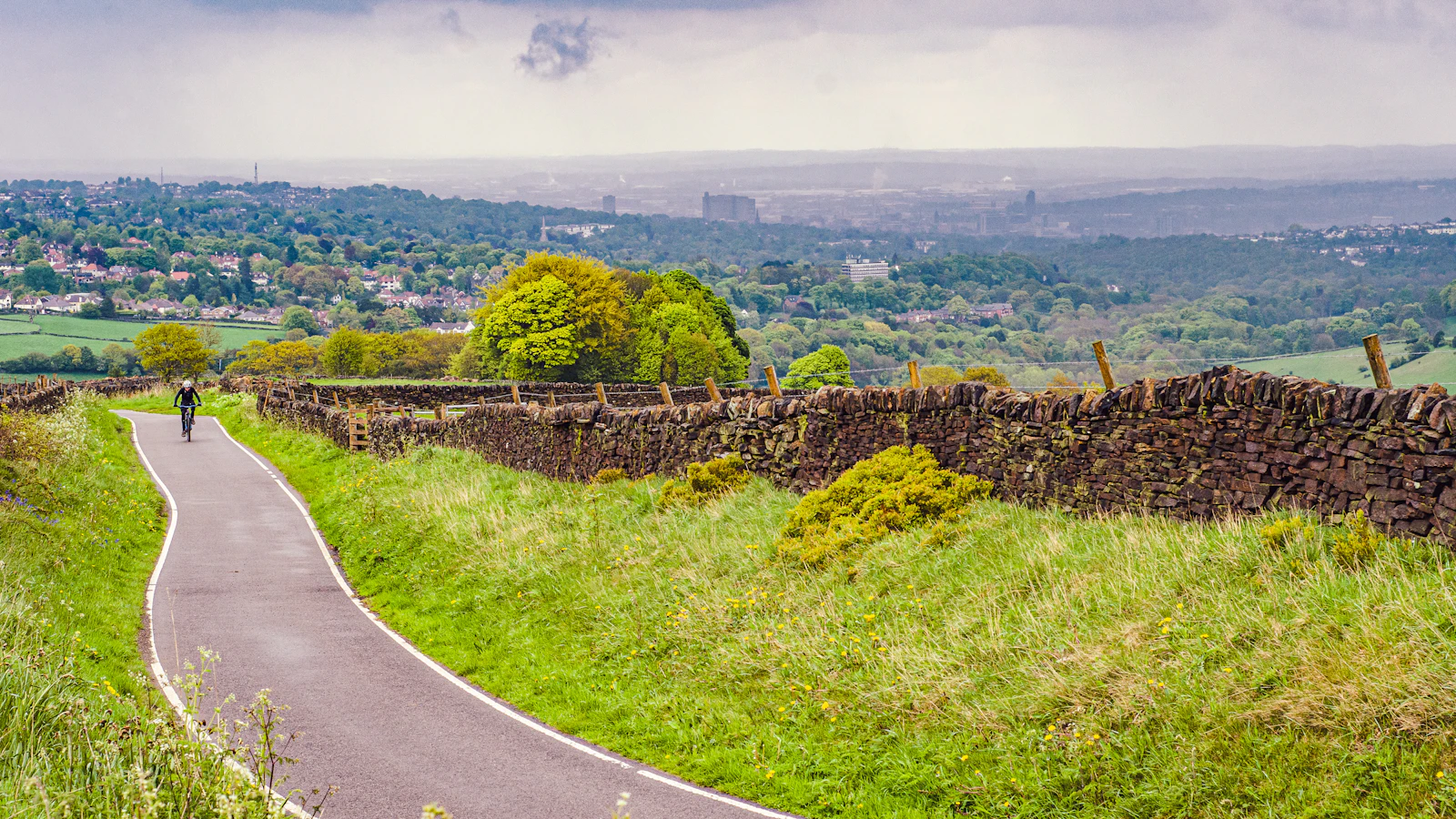 A road running through a green countryside landscape