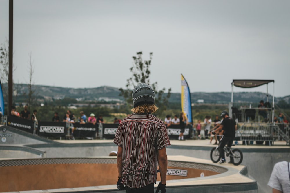 person wearing brown button-up shirt and gray beanies