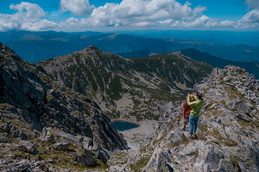 person standing on edges of mountian