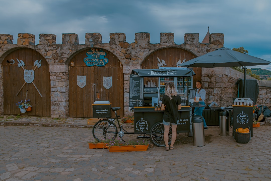 unknown person standing near green food cart