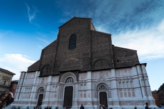 A group of people gathered in front of a damaged church, discussing plans for restoration.