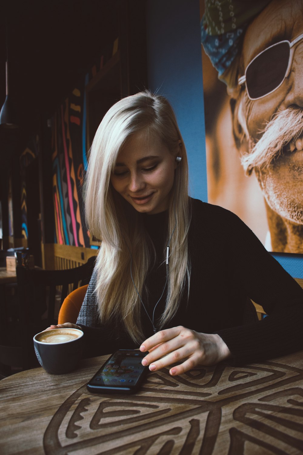 woman sitting near blue wall