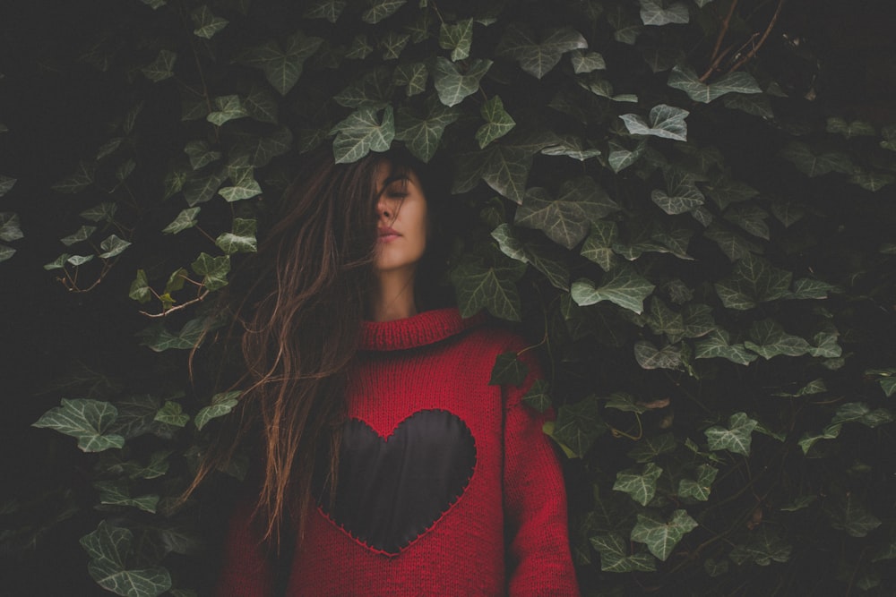 woman standing beside plant