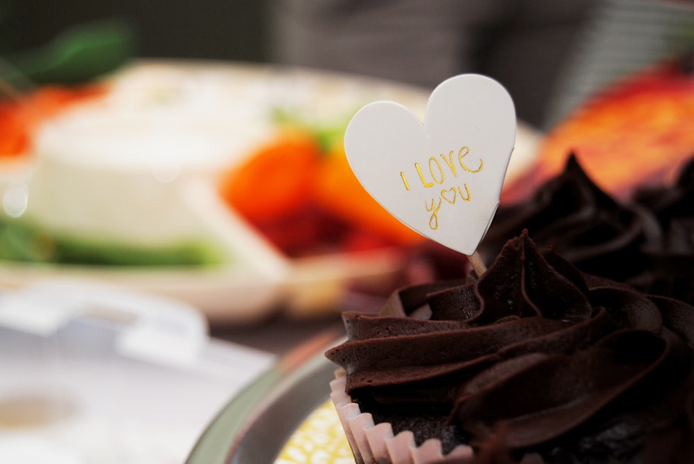 a close up of a cupcake with a heart on top